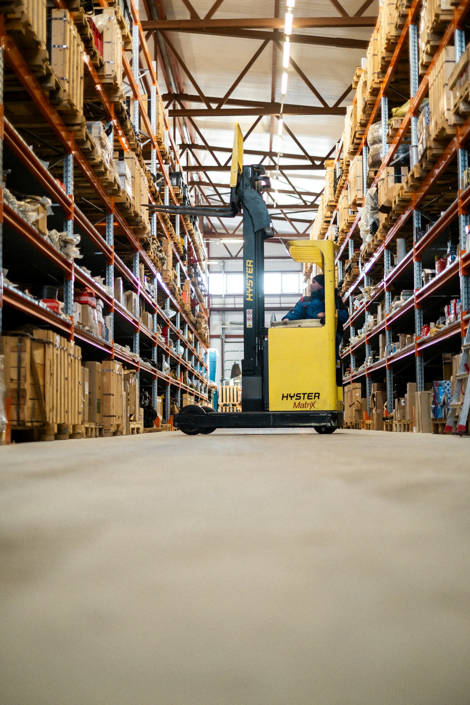 Forklift moving through a warehouse aisle